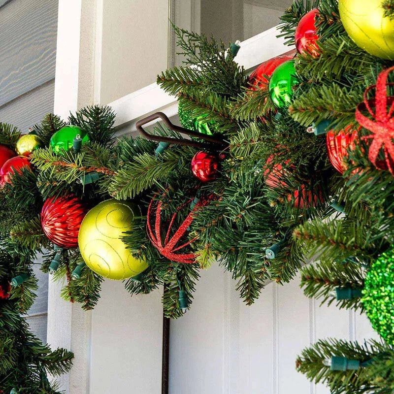 Christmas garland with colorful ornaments on a door