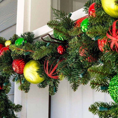 Christmas garland with colorful ornaments on a door