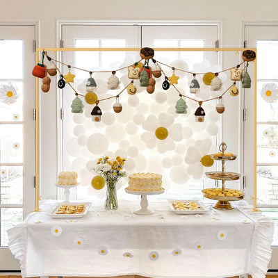 Decorated room with a dessert table, garland, and floral arrangements.