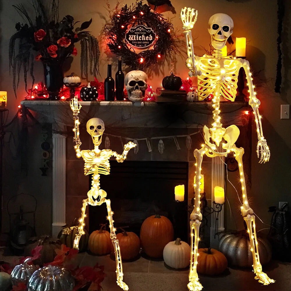 Halloween decorations with skeletons, pumpkins, and lights on a fireplace.
