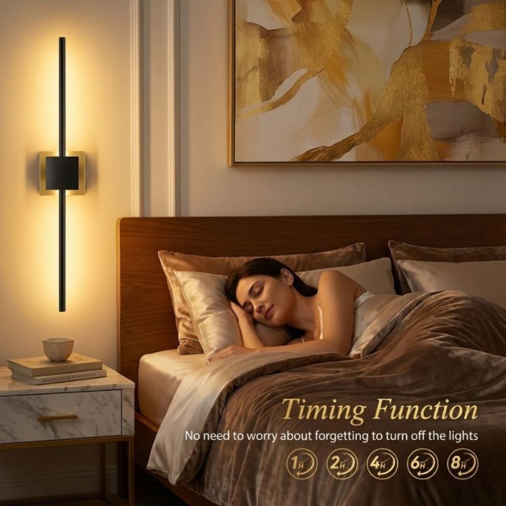 Woman sleeping in a bedroom with a wall light and abstract painting.