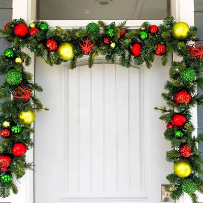 Christmas garland with colorful ornaments on a white door